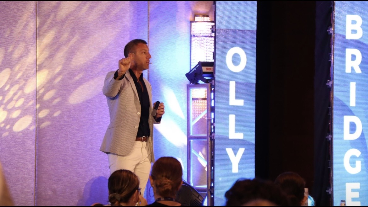 Olly Bridge leading an interactive session on a conference stage